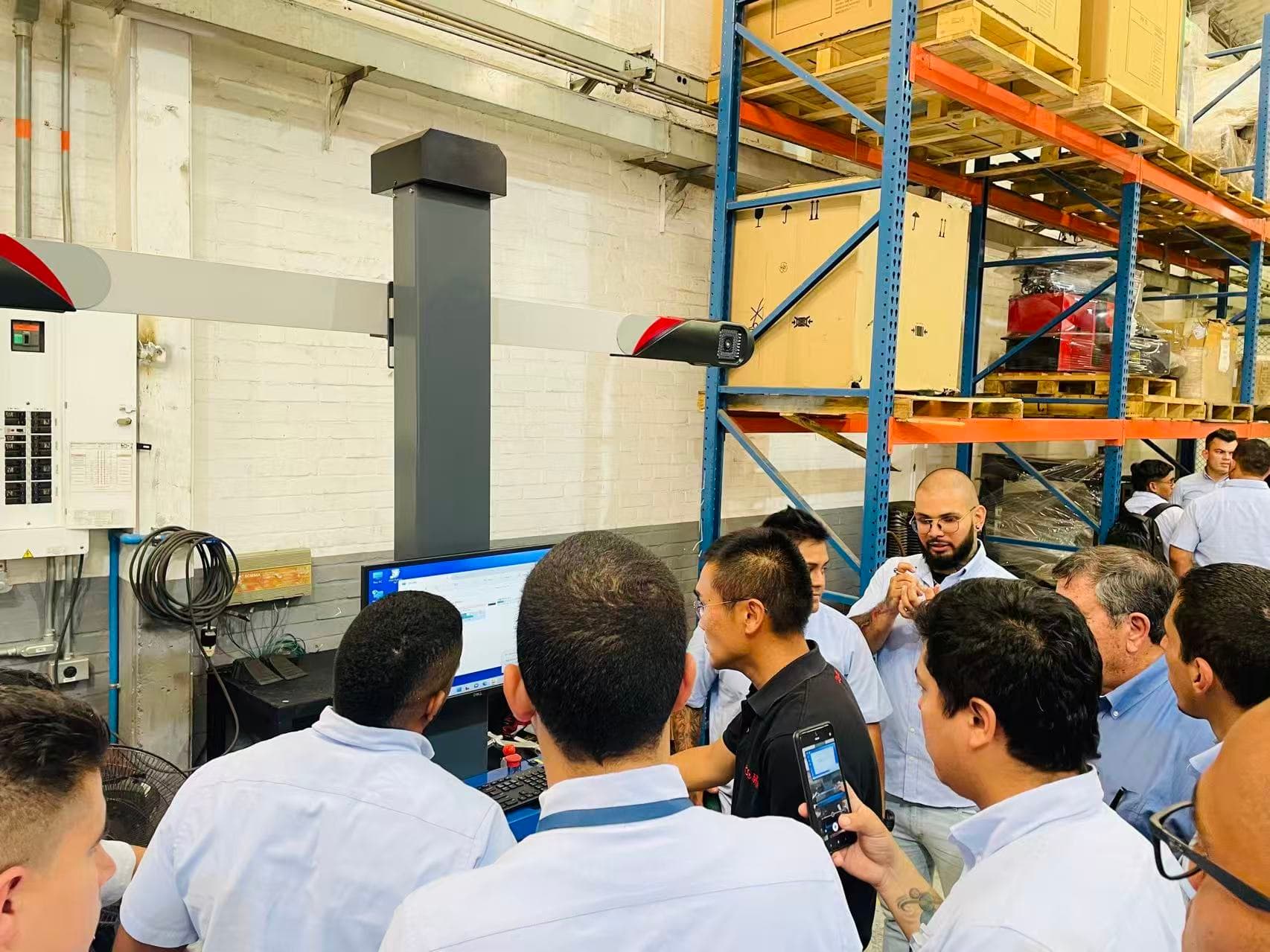 Yan Zhu delivering wheel aligner product training to a distributor team in Cali, Colombia