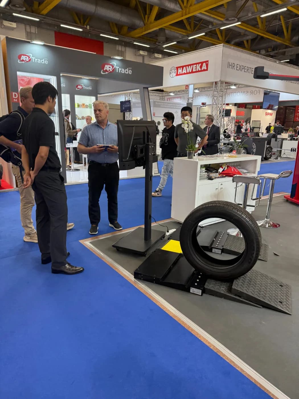 Visitor reviewing wheel-service equipment at the Bologna exhibition