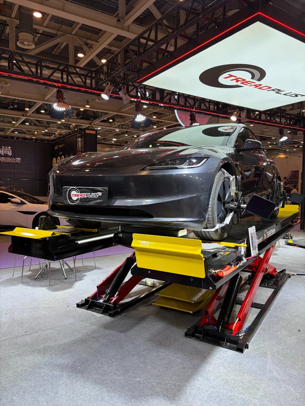 Vehicle on an alignment lift at the TreadPlus GT Show 2026 display
