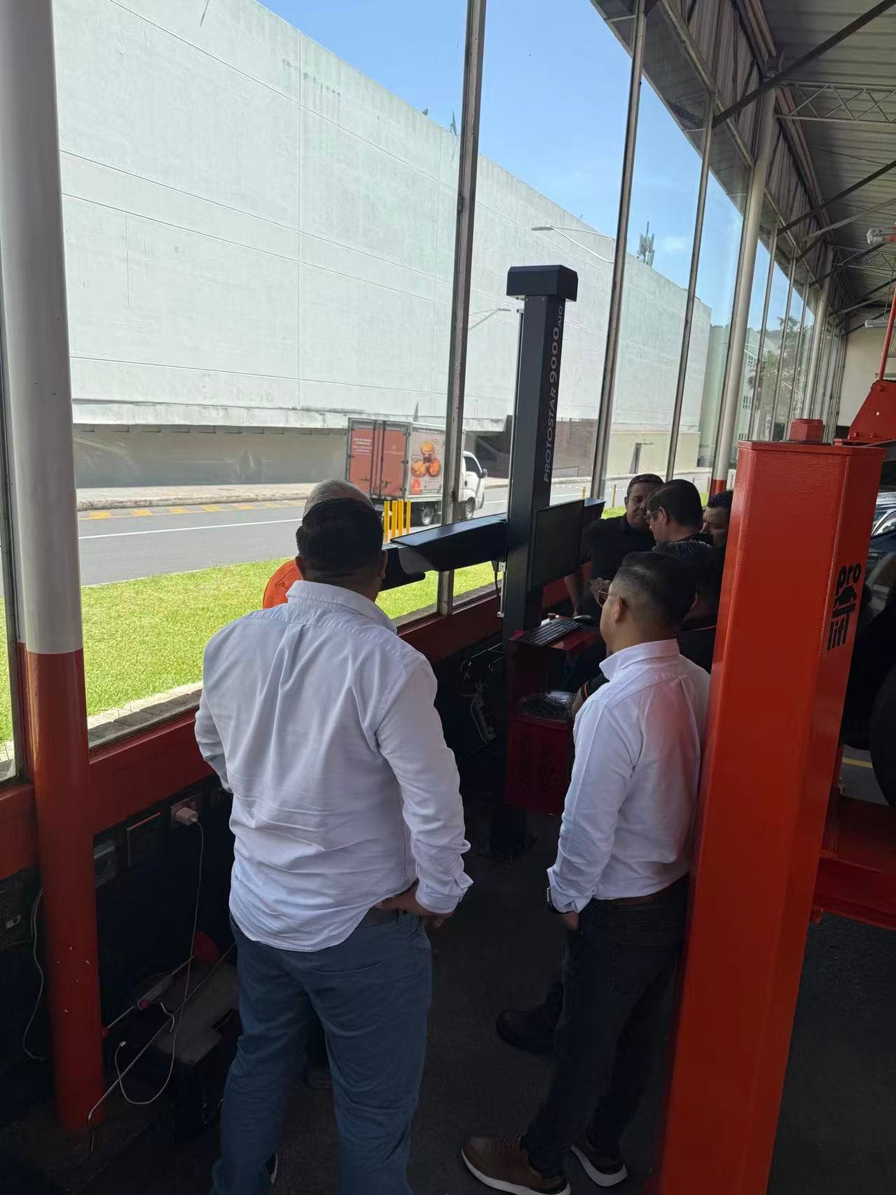 Allan Monge and the local distributor providing customer wheel aligner training in Santa Catarina Pinula, Guatemala